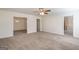 Inviting living room featuring an open layout, ceiling fan, neutral paint, and doorways to adjacent rooms at 1491 Hada Ln, Lawrenceville, GA 30044