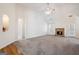 Living room features vaulted ceilings, a fireplace, neutral carpet and a ceiling fan at 1491 Hada Ln, Lawrenceville, GA 30044