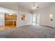 Living room features a view to the kitchen, neutral carpet and neutral paint at 1491 Hada Ln, Lawrenceville, GA 30044