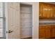 Pantry area with storage shelves, wood floors, and wood cabinets at 1491 Hada Ln, Lawrenceville, GA 30044
