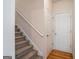 Carpeted staircase leading to the upper level with a closed white door at 1491 Hada Ln, Lawrenceville, GA 30044