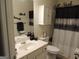 Cozy bathroom featuring a single vanity, white cabinets, and a decorative shower curtain at 2742 Keystone Gates Ct, Lithonia, GA 30058
