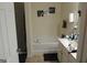 Clean bathroom with a tub-shower combo, neutral tile, and a functional vanity area at 2742 Keystone Gates Ct, Lithonia, GA 30058