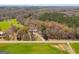 Aerial view of a house surrounded by green fields and trees in a peaceful, rural setting at 327 Old Muse Rd, Carrollton, GA 30116