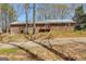 Image showing the back of this brick home with a door with red trim and a small deck with red trim at 327 Old Muse Rd, Carrollton, GA 30116