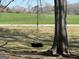 Close up of the tire swing hanging from a large tree in the backyard at 327 Old Muse Rd, Carrollton, GA 30116