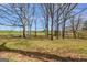 Picture of the homes backyard with large trees and clearings at 327 Old Muse Rd, Carrollton, GA 30116