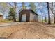 Exterior view of a barn with gray siding, surrounded by trees at 327 Old Muse Rd, Carrollton, GA 30116
