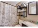 Well-lit bathroom featuring a shower, a vanity with a sink, and modern fixtures at 327 Old Muse Rd, Carrollton, GA 30116