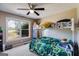 Comfortable bedroom with a bunk bed, a ceiling fan, and a large window with scenic view at 327 Old Muse Rd, Carrollton, GA 30116