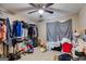 Spacious bedroom with clothing racks, a ceiling fan, and a disorganized area at 327 Old Muse Rd, Carrollton, GA 30116