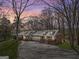 Inviting house exterior with a beautiful sky and surrounding trees at dusk at 327 Old Muse Rd, Carrollton, GA 30116