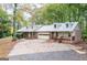 View of the home's facade, garage, and landscaping at 327 Old Muse Rd, Carrollton, GA 30116