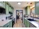 Modern kitchen with green cabinets, white countertops, and stainless steel appliances at 327 Old Muse Rd, Carrollton, GA 30116