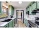 Modern kitchen with green cabinets and stainless steel appliances at 327 Old Muse Rd, Carrollton, GA 30116