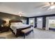 Spacious main bedroom featuring a large bed, ceiling fan, and access to a private balcony at 327 Old Muse Rd, Carrollton, GA 30116