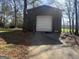Outbuilding with roll up garage door and adjacent yard at 327 Old Muse Rd, Carrollton, GA 30116