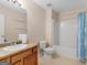 Bright bathroom featuring a vanity, toilet, and shower with a curtain at 1100 Parkside Ln, Mcdonough, GA 30253