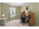 Cozy bedroom features a desk, chair, and a sunny window for a functional workspace at 1100 Parkside Ln, Mcdonough, GA 30253