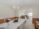 Inviting dining room with a chandelier, wainscoting, and a view into the adjacent living room at 1100 Parkside Ln, Mcdonough, GA 30253