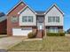 Charming two-story home with brick and siding, green shutters, and well-manicured front yard at 1100 Parkside Ln, Mcdonough, GA 30253