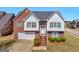 Two-story home with brick and siding exterior, landscaped yard, and attached garage at 1100 Parkside Ln, Mcdonough, GA 30253