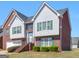 Attractive two-story home featuring brick and gray siding, green shutters, and a landscaped front yard at 1100 Parkside Ln, Mcdonough, GA 30253