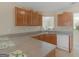 Cozy kitchen with wood cabinets, laminate counters, and essential appliances including a dishwasher at 1100 Parkside Ln, Mcdonough, GA 30253