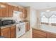 A functional kitchen featuring a gas range, microwave, and breakfast bar at 1100 Parkside Ln, Mcdonough, GA 30253