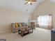 Bright living room with vaulted ceiling, neutral carpet, cozy furniture, and a fireplace at 1100 Parkside Ln, Mcdonough, GA 30253