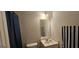 Neutral bathroom featuring a vanity with mirror and shower with blue curtain at 255 Squire Ln, Fayetteville, GA 30214