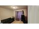 Cozy room with black futon, carpeted flooring, and purple curtains at 255 Squire Ln, Fayetteville, GA 30214