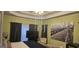 Cozy bedroom featuring a tray ceiling, large windows, and an accent wall for a touch of elegance at 255 Squire Ln, Fayetteville, GA 30214