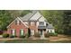 Charming two-story home featuring a brick facade, gray siding, and well-manicured landscaping at 255 Squire Ln, Fayetteville, GA 30214
