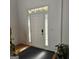 Bright foyer with white door, sidelights, transom window, and neutral decor at 255 Squire Ln, Fayetteville, GA 30214
