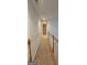Bright hallway featuring neutral carpet, with white walls and wood railing at 255 Squire Ln, Fayetteville, GA 30214