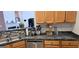 Kitchen with stainless steel dishwasher and sink, dark countertops, and wood cabinets for a traditional feel at 255 Squire Ln, Fayetteville, GA 30214