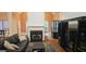 A cozy living room is displayed, complete with a fireplace, hardwood floors, and an entertainment center at 255 Squire Ln, Fayetteville, GA 30214