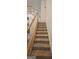 Carpeted staircase with wooden railing leading to the upper level at 255 Squire Ln, Fayetteville, GA 30214