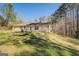 Backyard view of the house exterior showing well-kept lawn on a sunny day at 178 Norman Rd, Covington, GA 30014