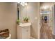 Bathroom featuring a vanity, mirror, and a hallway leading to other rooms at 178 Norman Rd, Covington, GA 30014