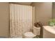 Bathroom with a toilet, shower with curtain, vanity, and a woven basket at 178 Norman Rd, Covington, GA 30014
