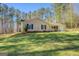 Inviting single-story home with a well-maintained lawn and mature trees at 178 Norman Rd, Covington, GA 30014