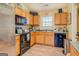 Functional kitchen with wooden cabinets and essential appliances, providing a practical cooking space at 178 Norman Rd, Covington, GA 30014