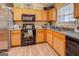 A charming kitchen with wooden cabinets, black appliances, and decorative accents at 178 Norman Rd, Covington, GA 30014