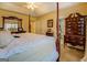 Spacious main bedroom with a four-poster bed, natural light, and ensuite bathroom at 178 Norman Rd, Covington, GA 30014