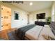 Digitally staged bedroom showcases modern decor, a TV, bed and rug, providing a furnished feel at 6268 Mount Zion Blvd, Morrow, GA 30260