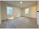 Large bedroom featuring two windows, light-colored walls, and wood-look floors at 6268 Mount Zion Blvd, Morrow, GA 30260