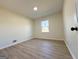 Empty bedroom shows light-colored walls, wood-look floors, and one window at 6268 Mount Zion Blvd, Morrow, GA 30260