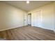 Bedroom features light-colored walls, wood-look floors, and a closet with sliding doors at 6268 Mount Zion Blvd, Morrow, GA 30260